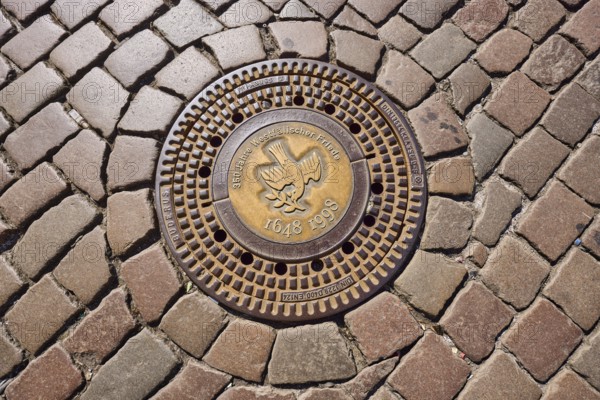 Manhole cover, 350 years of the Peace of Westphalia, 1648 to 1998, golden, cobblestones, biblical