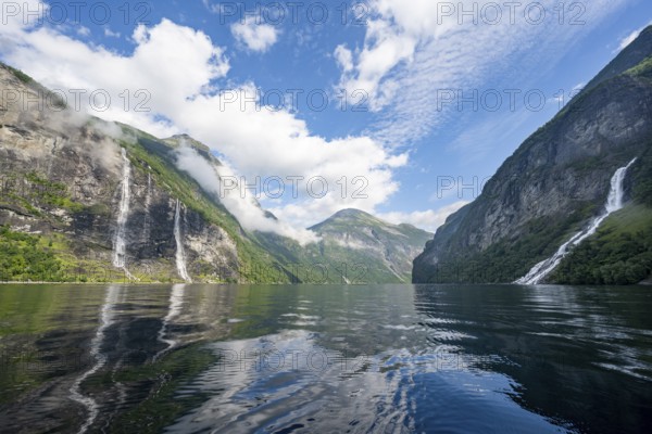 Atmospheric fjord landscape with waterfall The Seven Sisters and Freier Waterfall, Geirangerfjord