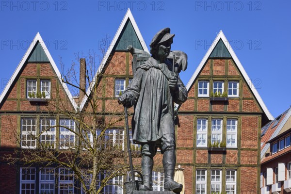 Kiepenkerl monument, bronze sculpture, brick architecture, facade, window, blue cloudless sky,
