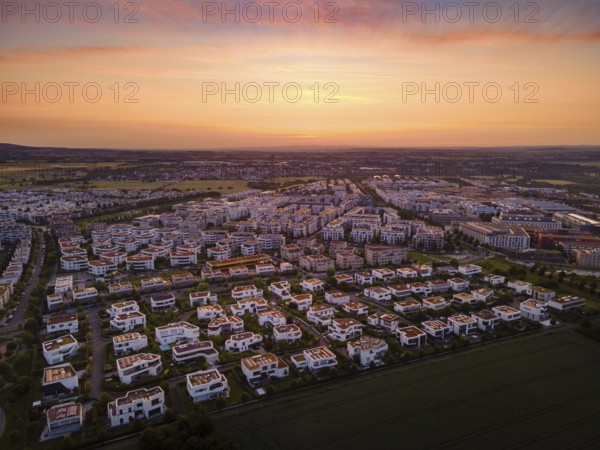 Dawn behind the Riedberg district of Frankfurt heralds the imminent sunrise. (Aerial view with a