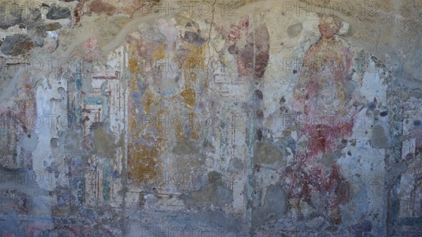 Faded frescoes on ancient wall with figures and paint remains, Archaeological Site, House of Beluga