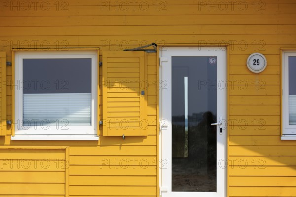 Yellow bungalow, holiday home, wooden house, facade detail with glass door and window, Insel Düne,