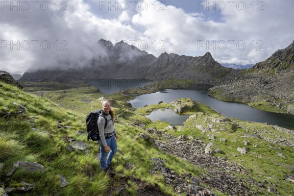 Mountaineer on hiking trail, view of mountain landscape with mountain lakes Wangenitzsee and