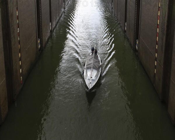 Maasbracht, Limburg, The Netherlands, 04 20 2022, Large sluice gate with a small vessel passing by,