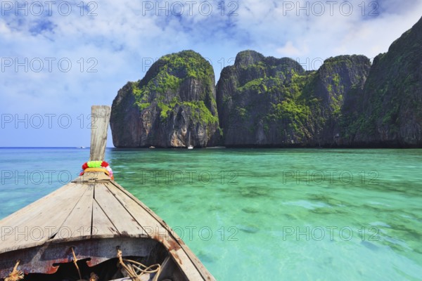 Boat trip on the native boat. Sea water is emerald green and the islands covered with green plants.