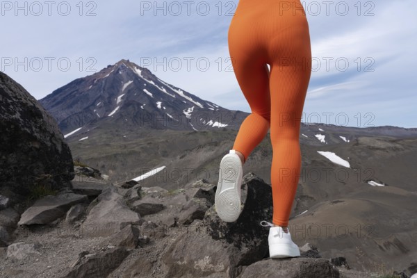 Closeup woman in figure hugging sports leggings showing off buttocks and legs. Athletic woman doing