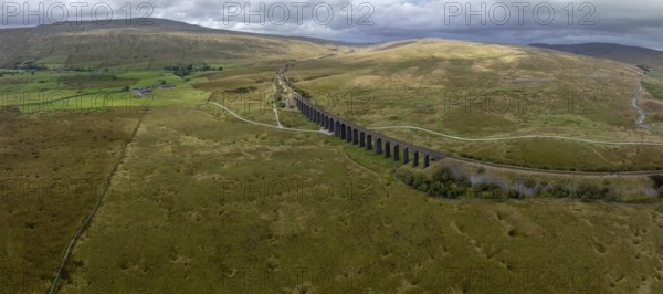 Ribblehead Viaduct, railway viaduct in the Yorkshire Dales, behind Whernside mountain, drone shot,