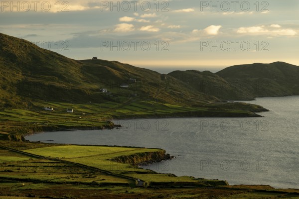 Coastal landscape on the Ring of Kerry near Waterville, with green fields and scattered houses in