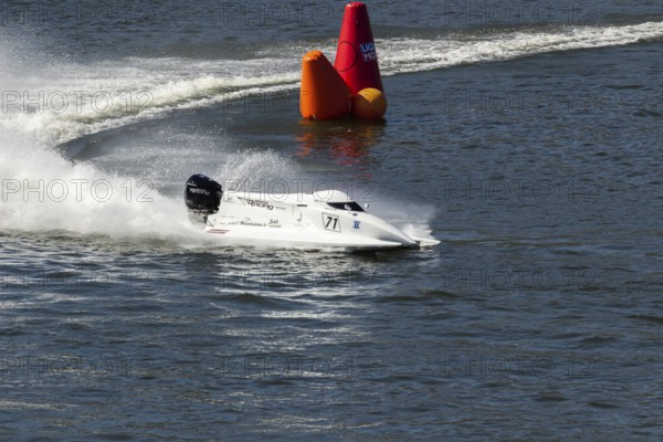 PESO DA REGUA, PORTUGAL - SEPTEMBER 15, 2024: White Powerboat Makes Sharp Turn with Splashes of