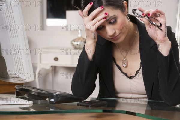 Woman at computer desks looks frustrated