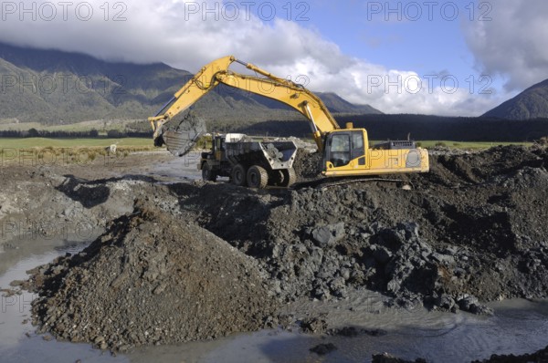 30 ton digger collects blue clay for lining an effluent pond next to a rotary dairy in Westland,