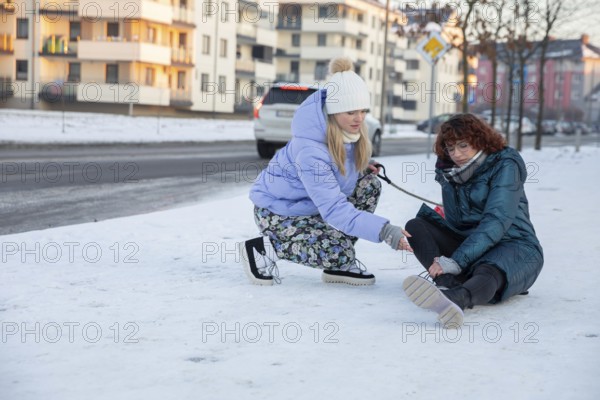 A woman, who was out walking her dog, tries to help a person who fell over in the snow. The girl