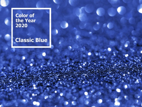 Sparkling background with bokeh made of Classic Blue 2020 color. Color of year 2020 blurred
