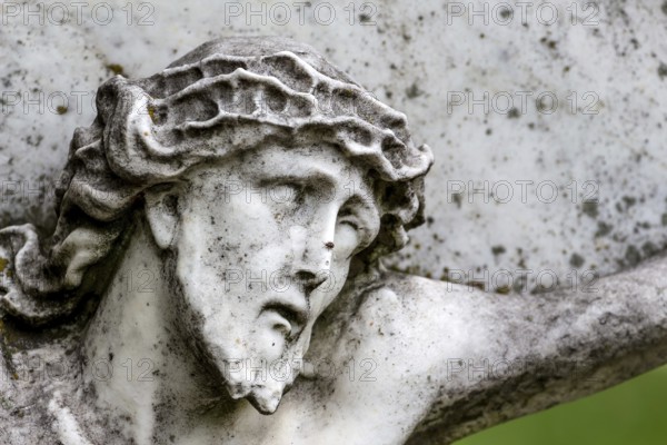 Crucifixion of Jesus on a gravestone in the Barbarafriedhof cemetery in Linz, Austria, Suffering