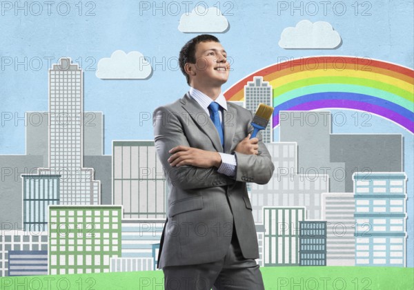 Confident and creative businessman painter standing with arms folded. Happy handsome man in