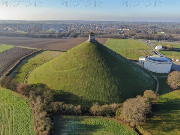 Aerial view of The Lion's Mound with farm land around. The immense Butte Du Lion on the battlefield