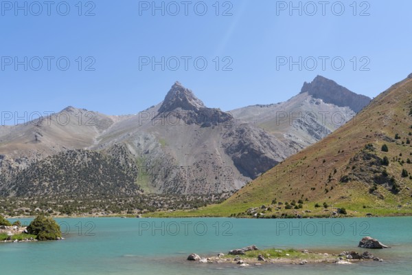 The Pamir range view and peaceful campsite on Kulikalon lake in Fann mountains in Tajikistan.