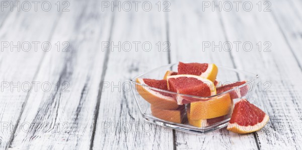 Chopped Grapefruits (selective focus) on a vintage background as detailed close-up shot