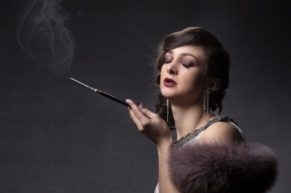 Retro portrait of a woman. A beautiful woman in the style of the 20s and 30s with a cigarette