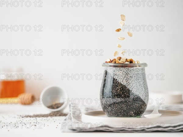 Healthy breakfast concept and idea - two colors chia pudding with organic raw almond. Glass jar
