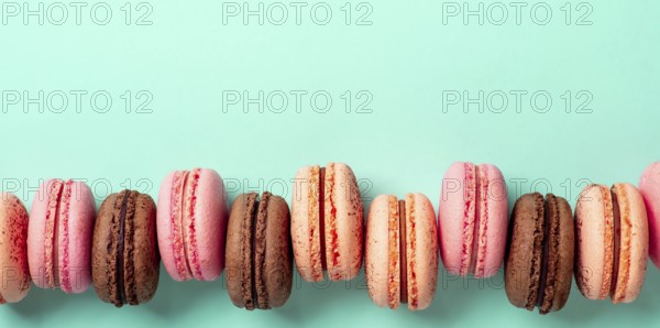 Macarons banner with copy space. Colorful french macarons or macaroons on blue turquoise background