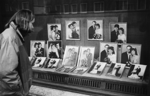 05/03/1983 GDR district of Cottbus town of Spremberg. Young woman looks into the shop window of the