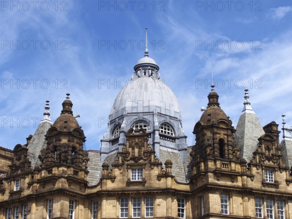 Ornate stone towers and domes on the roof of leeds city market a historical building in west