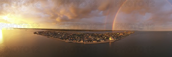 Rain falls as sun shines in the middle of the night at Kotzebue Alaska creating a beautiful