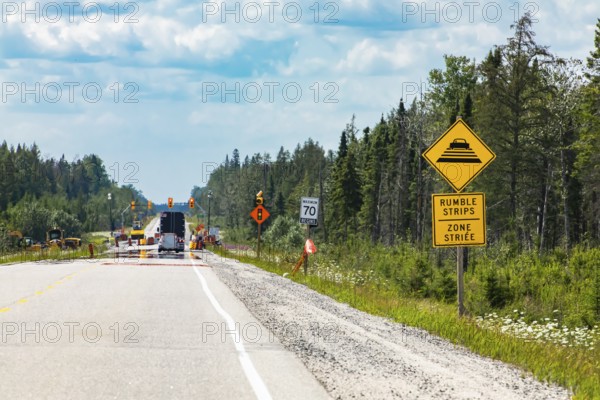 Temporary condition road warning signs on the roadside before road work zone, rumble strips on a