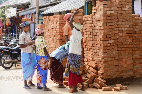 Kanchipuram, Tamil Nadu, South India, India, Asia, Group of labourers stacking bricks on the