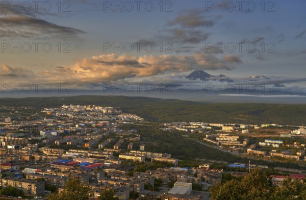 Petropavlovsk-Kamchatsky city at sunset and cone of Koryak volcano. Kamchatka Peninsula, Russia,
