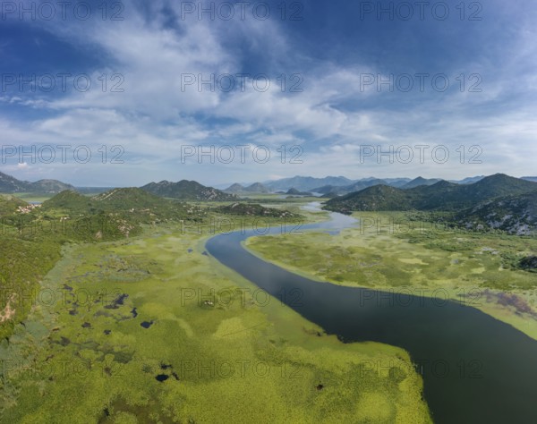 Aerial view of Rijeka Crnojevica, beautiful river between mountains flowing into Skadar Lake,
