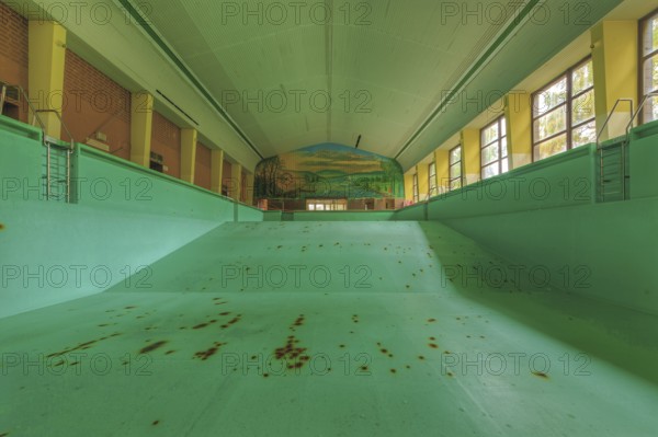 Abandoned, empty swimming pool with rust stains and wall painting, Bad am Südpark, Essen-Kray,