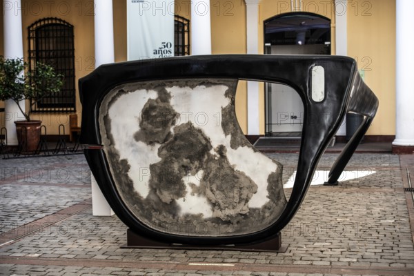 Broken horn-rimmed glasses as a work of art in memory of Salvador Allende Gossens in the courtyard