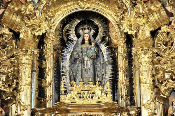 Detail of a Baroque altar with a gilded statue of the Madonna and Child Jesus, Iglesia de Santa
