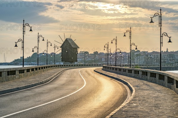 The wooden windmill on the isthmus at sunrise in Nessebar ancient city on the Bulgarian Black Sea