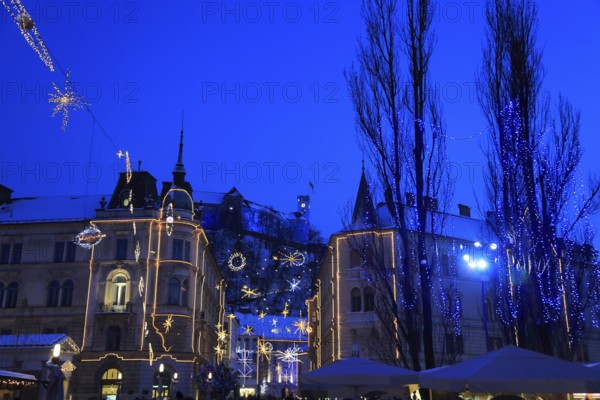 The Three Bridges over the Ljubljanica River, Ljubljana Castle at dusk at Christmas time, Ljubljana