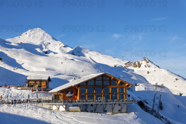 Ski Slope with Overhead Cable Car and Restaurant at 2000 Meters High Up and Mountain Peak in a