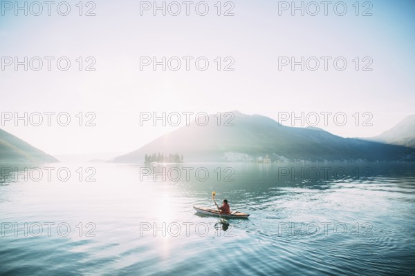 Kayaks in the lake. Tourists kayaking on the Bay of Kotor, near the town of Perast in Montenegro.