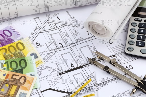 An architect's construction plan with a pocket calculator and euro money. Symbolic photo for
