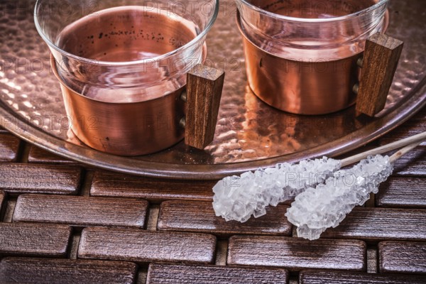 Close up view of coppery tray tea cups sugar sticks