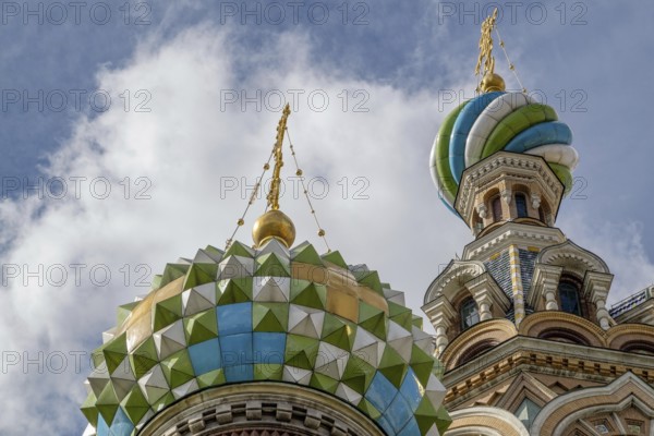 Top view of a church with colourfully decorated domes and golden spires under a cloudy sky, Saint