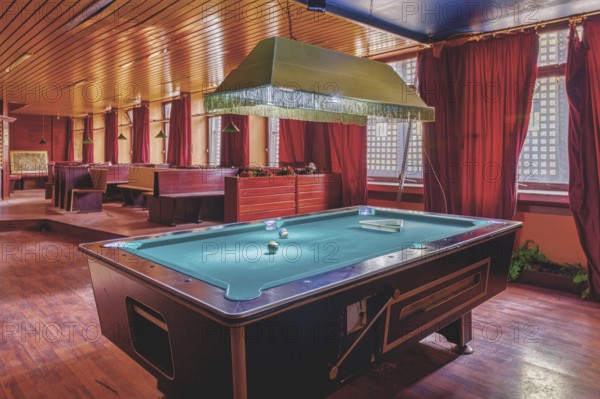 A room with a pool table in the centre, red curtains and a wooden ceiling, Bad am Park, Lost Place,