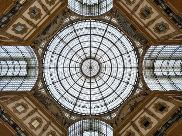 Round stained-glass windows and arches on the ceiling of the Vittorio Emmanuel Gallery. Milan,