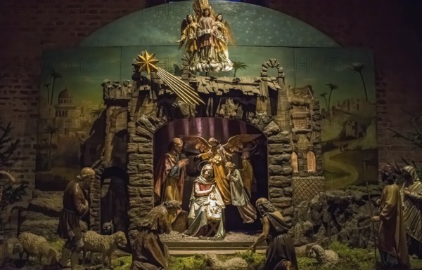 Traditional Christmas nativity scene with beautiful figures made out of wood. The birth of Jesus