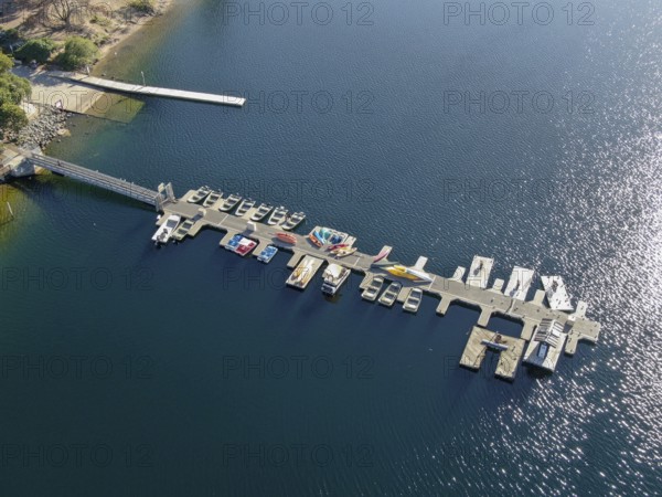 Aerial view of Miramar Lake small pier with pedal boat, small motor boat. Lake with popular