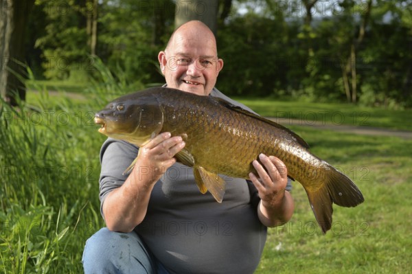 Proud fisherman with self captived carp