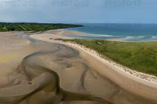 A panorama drone landscape view of the beautiful golden sand beach at Lacken Strand on the coast of