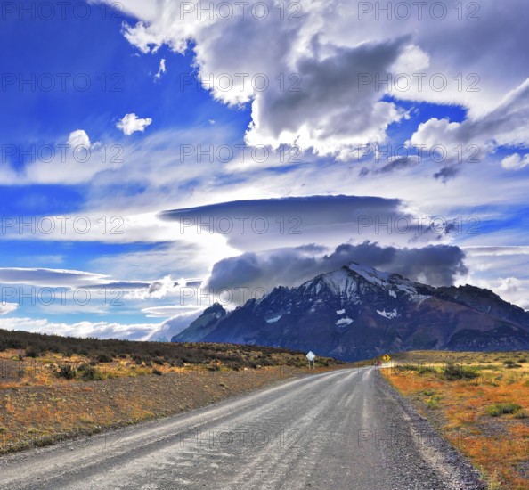 Stunning sunset in the Chilean Patagonia. Incredible clouds over the mountain glaciers. The dirt