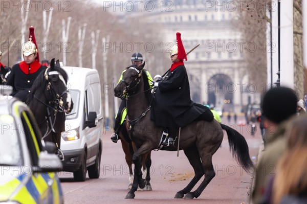 Mounted horse guards in ceremonial uniforms on a street in the City of Westminster, Greater London,